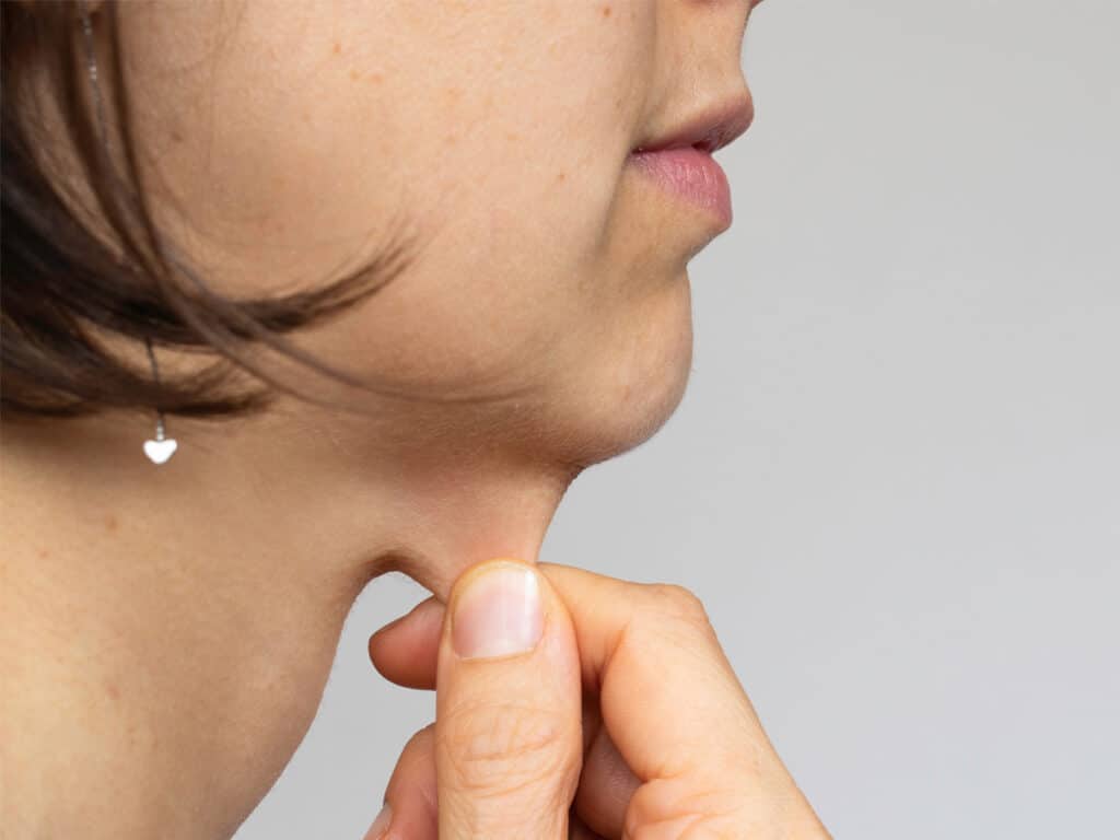 Loose and sagging skin on the neck can be caused by many factors such as aging, sun damage, weight fluctuations, genetics, and environmental conditions.