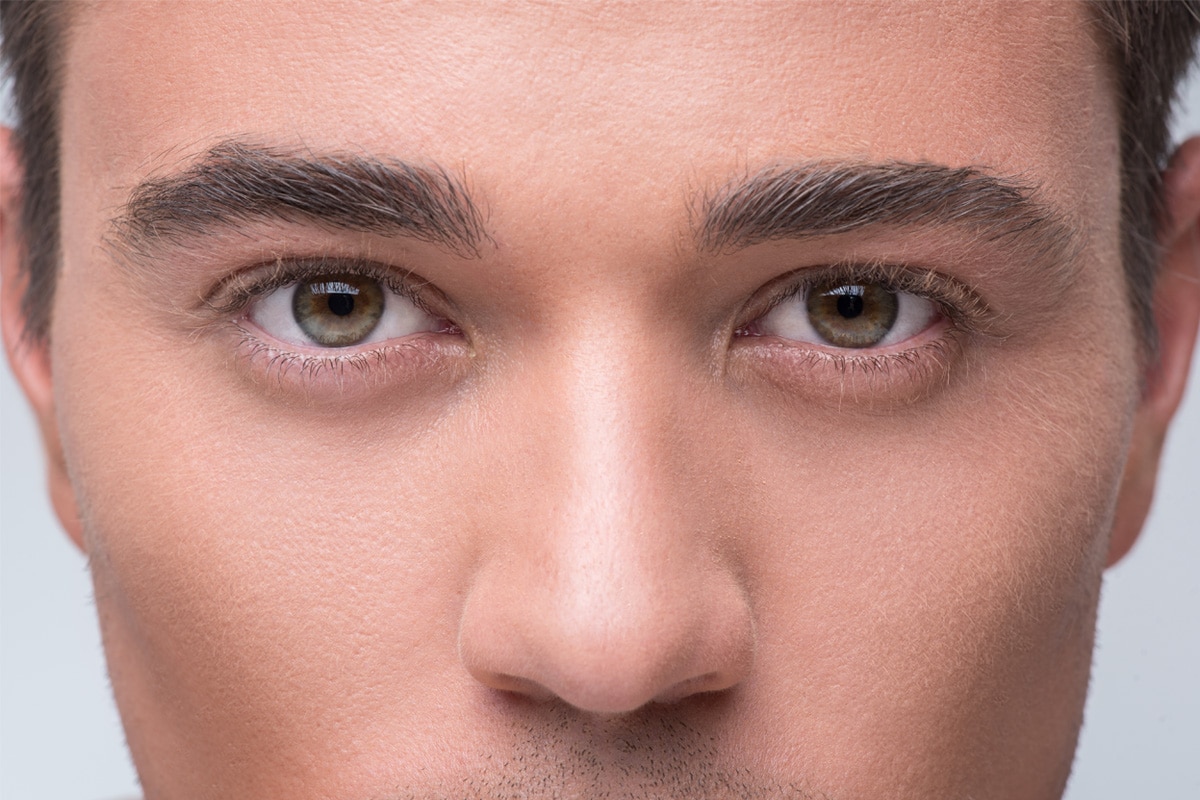 Close-up of a man's eyes and nose highlighting rhinoplasty results.