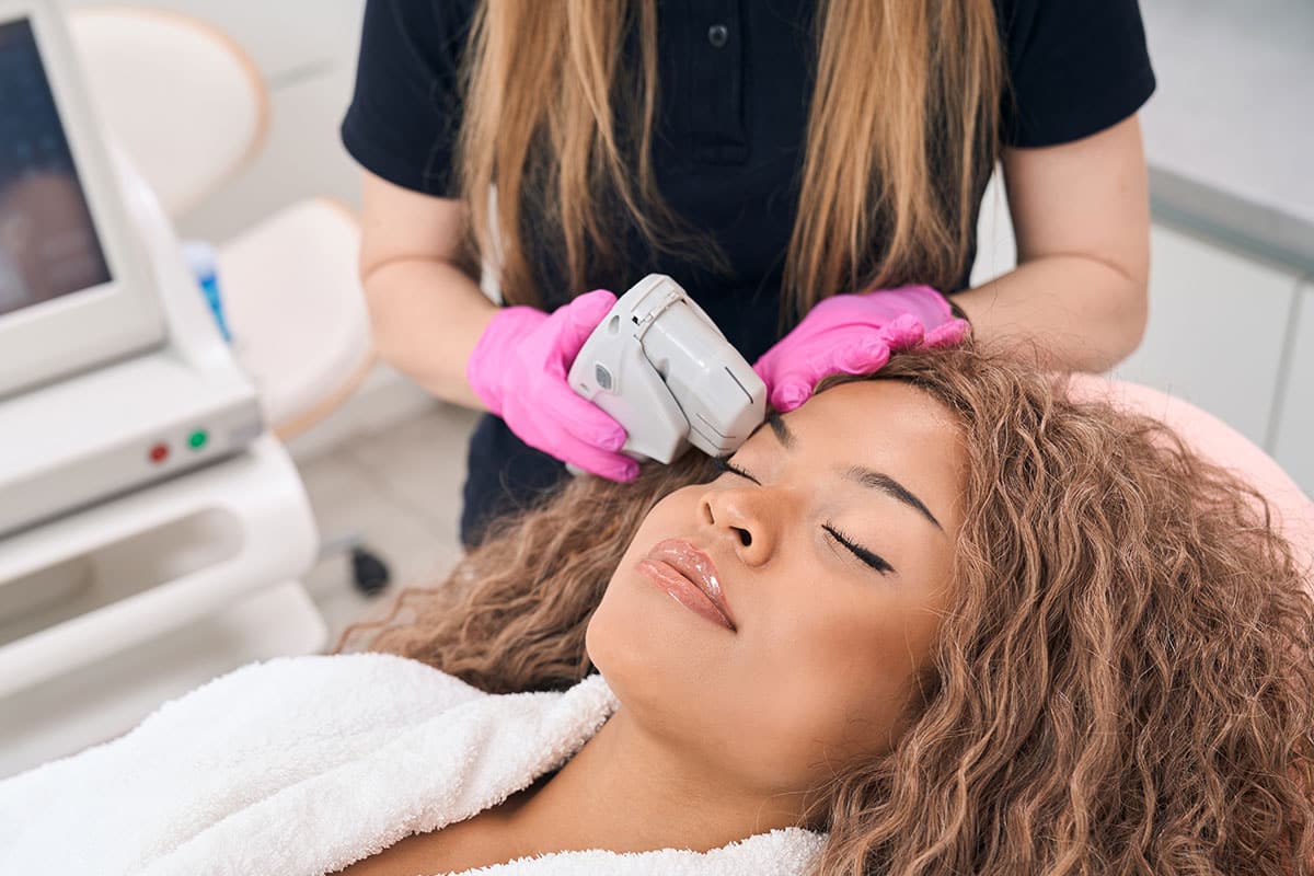 Female patient receiving a laser blepharoplasty treatment.