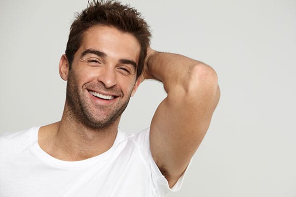 man smiling after his hair transplant in Miami