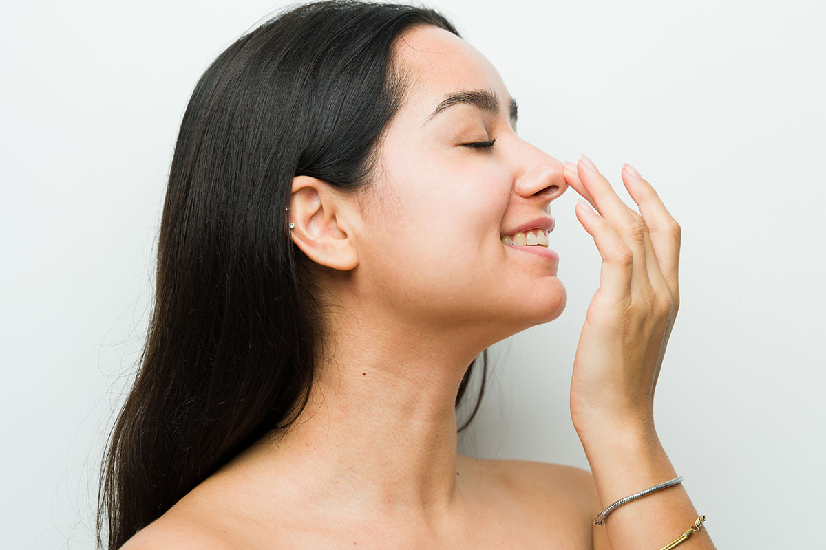 woman showing off her results after her rhinoplasty in Miami, FL